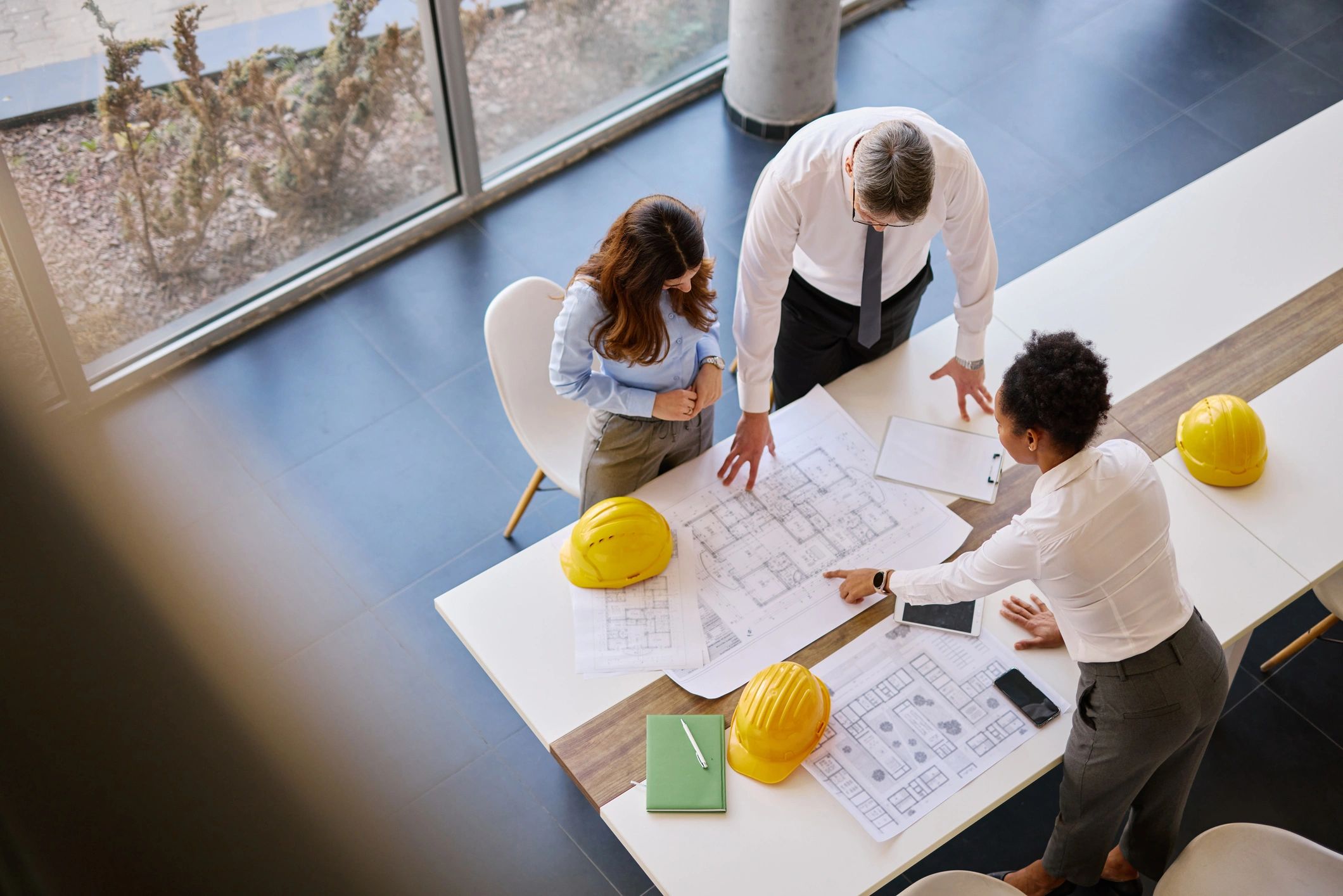 Architects reviewing blueprints together in a professional office